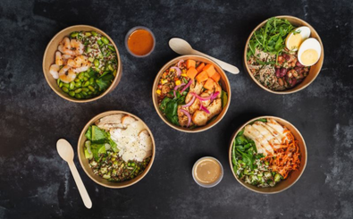 Five bowls of assorted salads with vegetables, grains, proteins, and dressings.
